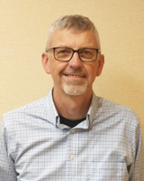 A photo of Ron Jacobson smiling.