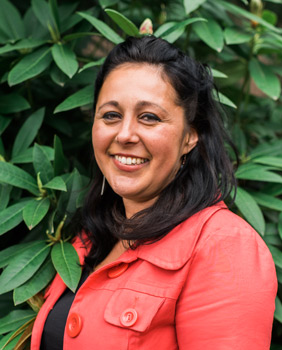 A portrait photo of Alexandra Manuel, smiling.